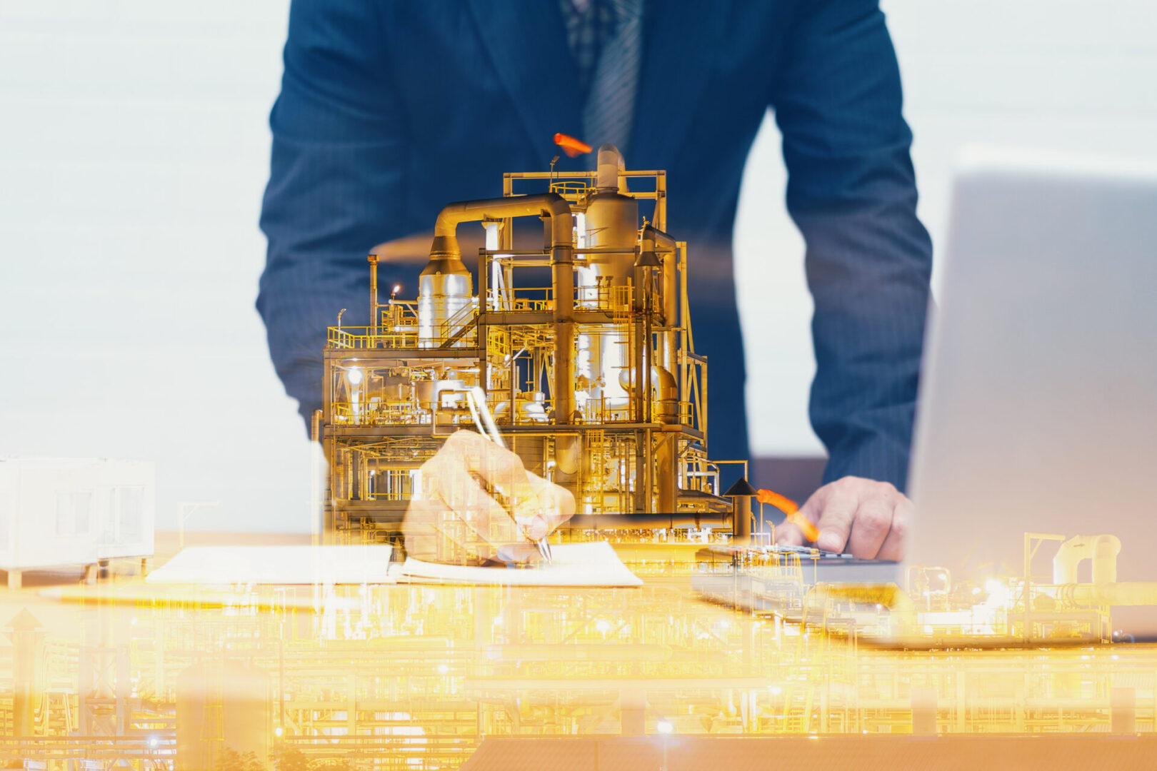 Double exposure of Engineering with oil refinery industry plant,engineer write industrial instruments plan in the factory and physical system with laptop, businessman Industry concept image
